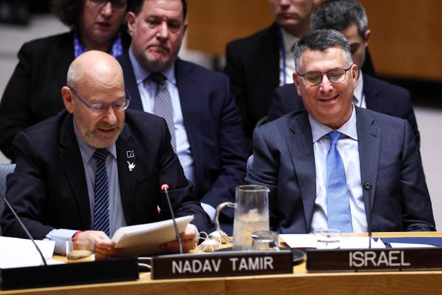 Israeli Foreign Minister Gideon Sa'ar (R) looks on as former Israeli diplomat Nadav Tamir (L) speaks during a United Nations Security Council meeting on the Middle East at UN headquarters in New York, on February 18, 2026. (Photo by CHARLY TRIBALLEAU / AFP)