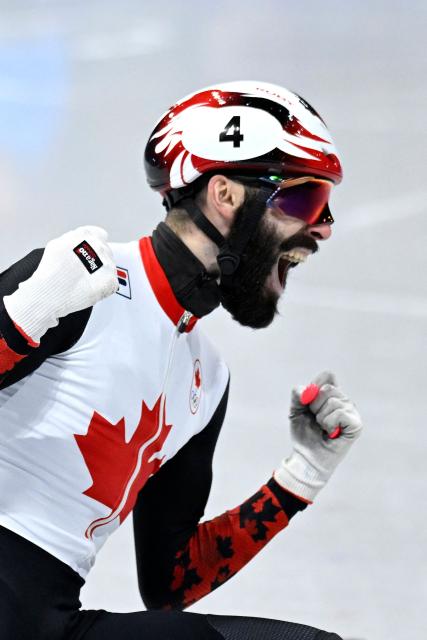 Canada's Steven Dubois celebrates after competing for gold in the short track speed skating men's 500m final during the Milano Cortina 2026 Winter Olympic Games at Milano Ice Skating Arena in Milan on February 18, 2026. (Photo by WANG Zhao / AFP)