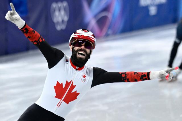 Canada's Steven Dubois celebrates after competing for gold in the short track speed skating men's 500m final during the Milano Cortina 2026 Winter Olympic Games at Milano Ice Skating Arena in Milan on February 18, 2026. (Photo by WANG Zhao / AFP)