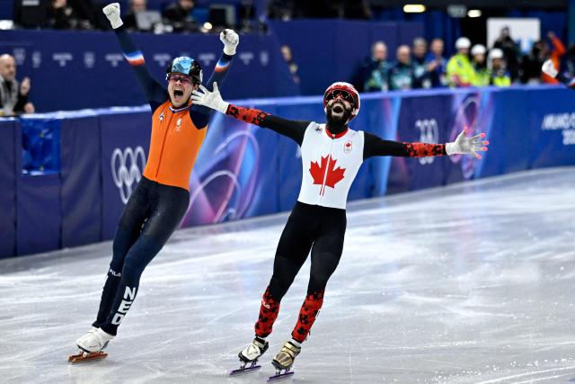 Canada's Steven Dubois celebrates after competing for gold in the short track speed skating men's 500m final during the Milano Cortina 2026 Winter Olympic Games at Milano Ice Skating Arena in Milan on February 18, 2026. (Photo by WANG Zhao / AFP)