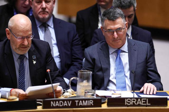 Israeli Foreign Minister Gideon Sa'ar (R) looks on as former Israeli diplomat Nadav Tamir (L) speaks during a United Nations Security Council meeting on the Middle East at UN headquarters in New York, on February 18, 2026. (Photo by CHARLY TRIBALLEAU / AFP)