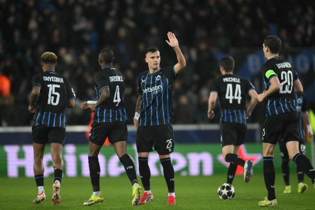 Club Brugge's Nigerian midfielder #15 Raphael Onyedika (L) celebrates scoring his team's first goal during the UEFA Champions League knockout round play-off first leg football match between Club Brugge and Atletico Madrid at the Jan Breydel Stadium in Brugge on February 18, 2026. (Photo by NICOLAS TUCAT / AFP)