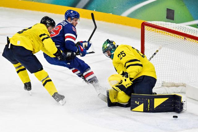 Sweden's #25 Jacob Markstrom makes a save during the men's play-off quarter-final ice hockey match between USA and Sweden at the Milano Santagiulia Ice Hockey Arena during the Milano Cortina 2026 Winter Olympic Games in Milan, on February 18, 2026. (Photo by Alexander NEMENOV / AFP)