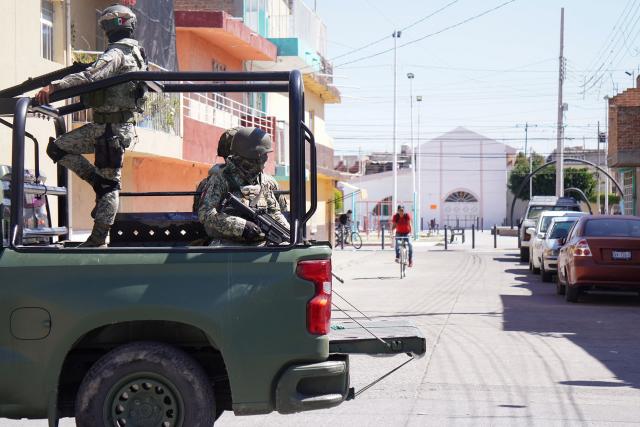 Mexican Army soldiers patrol a street a day after an armed attack on a playground in San Francisco del Rincon, Guanajuato state, Mexico on February 18, 2026. An armed attack in the state of Guanajuato, in central Mexico, left a 36-year-old man dead and at least eight youths injured on a playground on February 17, 2026, another violent episode in the region that provoked terror among local neighbors. (Photo by MARIO ARMAS / AFP)