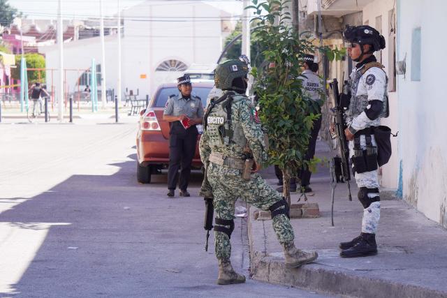 Mexican Army and National Guard soldiers stand guard a day after an armed attack on a playground in San Francisco del Rincon, Guanajuato state, Mexico on February 18, 2026. An armed attack in the state of Guanajuato, in central Mexico, left a 36-year-old man dead and at least eight youths injured on a playground on February 17, 2026, another violent episode in the region that provoked terror among local neighbors. (Photo by MARIO ARMAS / AFP)