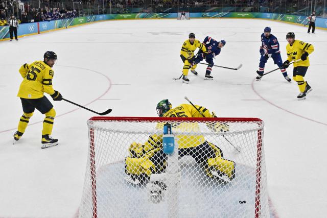USA's #43 Quinn Hughes shoots and scores his team's second goal to win the men's play-off quarter-final ice hockey match between USA and Sweden at the Milano Santagiulia Ice Hockey Arena during the Milano Cortina 2026 Winter Olympic Games in Milan, on February 18, 2026. USA wins 2 - 1 against Sweden and qualifies for the semi-finals. (Photo by Alexander NEMENOV / POOL / AFP)