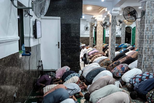 Muslim worshippers perform the evening prayer on the first day of the holy month of Ramadan at the Nadwat Global Assembly Mosque in Lagos Island on February 18, 2026. (Photo by Oyewole Lawal / AFP)