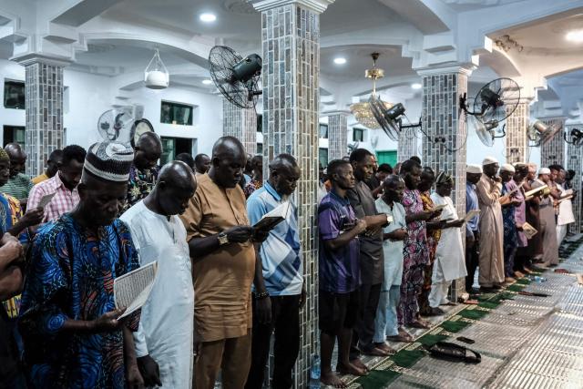 Muslim worshippers perform the evening prayer on the first day of the holy month of Ramadan at the Nadwat Global Assembly Mosque in Lagos Island on February 18, 2026. (Photo by Oyewole Lawal / AFP)