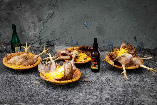 "Despachos," an offering ritual of the Afro-Brazilian Candomble religion, are seen on the ground during the Raimundo Bouzanfraim procession in the Pelourinho district of Salvador, Bahia state, Brazil, on February 18, 2026, marking the beginning of Ash Wednesday and celebrating Afro-Brazilian spirituality and ancestry. This year, the parade celebrates ancestry and Afro-Brazilian spirituality, with the theme of Exu as a symbol of movement, renewal and the connection between past, present and future. (Photo by Rafael Martins / AFP)