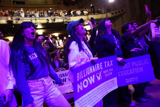 Attendees cheer during the speach of US Senator Bernie Sanders, Independent of Vermont, during the campaign kickoff for the California Billionaire Tax Act at The Wiltern in Los Angeles, February 18, 2026. Sanders is seeking the support of California voters for a November's ballot initiative of an emergency tax on billionaires to help the state's healthcare system. (Photo by Patrick T. Fallon / AFP)