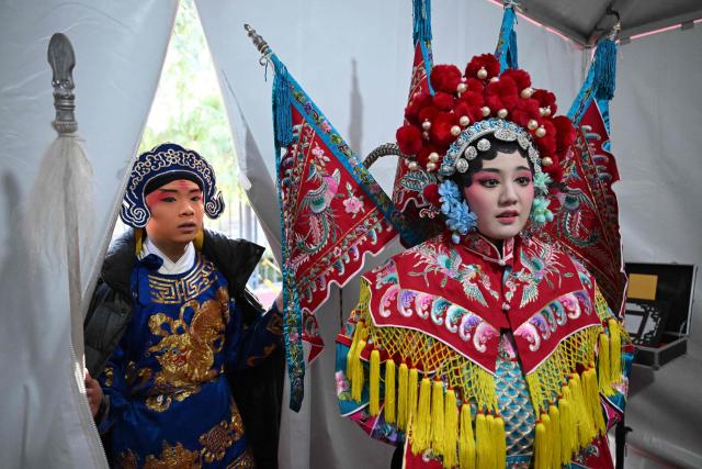 Chinese opera performers get ready for a performance at a Temple Fair on the third day of the Lunar New Year of the Horse in Beijing on February 19, 2026. (Photo by Pedro PARDO / AFP)