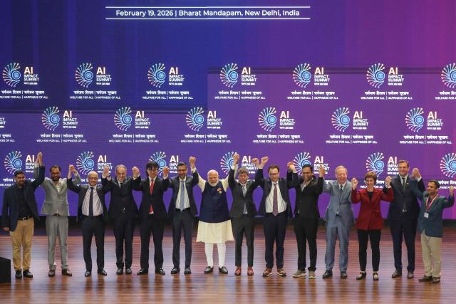 India's Prime Minister Narendra Modi (C) takes a group photo with AI company leaders at the AI Impact Summit in New Delhi on February 19, 2026. (Photo by Ludovic MARIN / AFP)