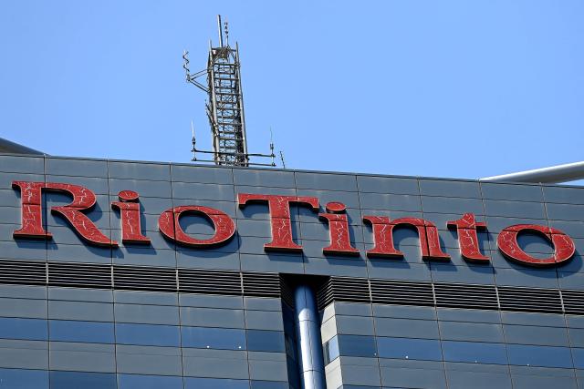 (FILES) This picture taken on November 26, 2024, shows the logo of Rio Tinto, a global mining and metals company, at the headquarters of its iron ore division in Perth, Western Australia. Mining giant Rio Tinto's net profit fell in 2025 as costs climbed and it took a hit from a slump in the Chinese economy, company results showed on February 19, 2026. (Photo by SAEED KHAN / AFP)