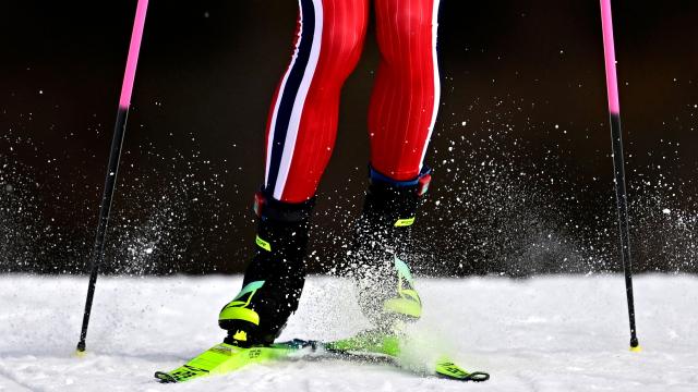 This photograph shows a view of the knees, legs and feet of Norway's Johannes Hoesflot Klaebo as he skies during the men's team cross country free sprint qualification event of the Milano Cortina 2026 Winter Olympic Games at Tesero Cross-Country Skiing Stadium in Lago di Tesero (Val di Fiemme), on February 18, 2026. (Photo by Tobias SCHWARZ / AFP)