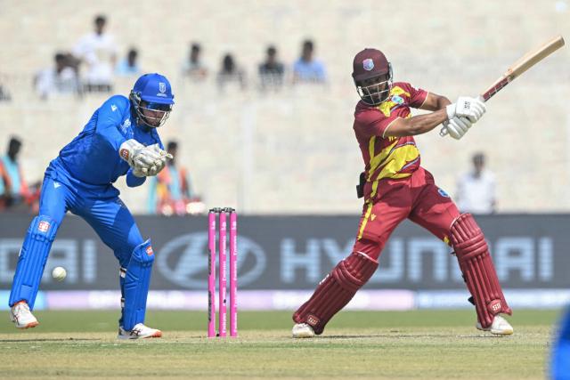 West Indies' captain Shai Hope (R) plays a shot as Italy's wicketkeeper Gian-Piero Meade (L) looks on during the 2026 ICC Men's T20 Cricket World Cup group stage match between West Indies and Italy at the Eden Gardens in Kolkata on February 19, 2026. (Photo by Dibyangshu SARKAR / AFP)