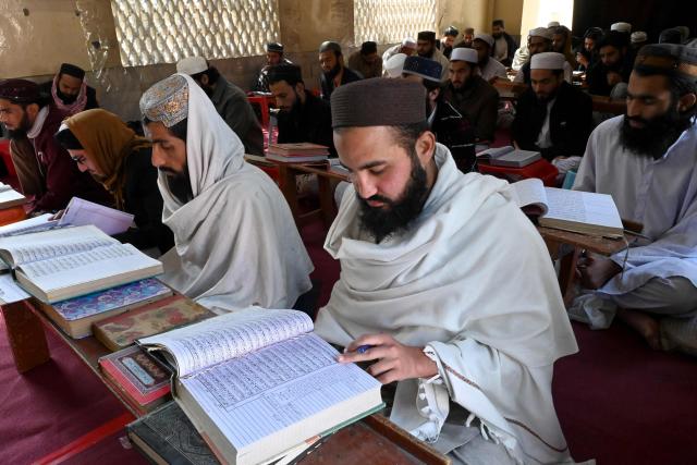Madrassa students recite the Quran on the first day of Islamic holy fasting month of Ramadan, in Peshawar on February 19, 2026. (Photo by Abdul MAJEED / AFP)