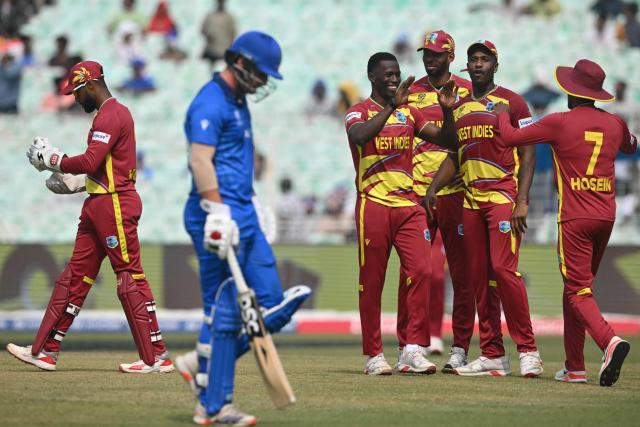 West Indies' players celebrate after the dismissal of Italy's captain Harry Manenti during the 2026 ICC Men's T20 Cricket World Cup group stage match between West Indies and Italy at the Eden Gardens in Kolkata on February 19, 2026. (Photo by Dibyangshu SARKAR / AFP)