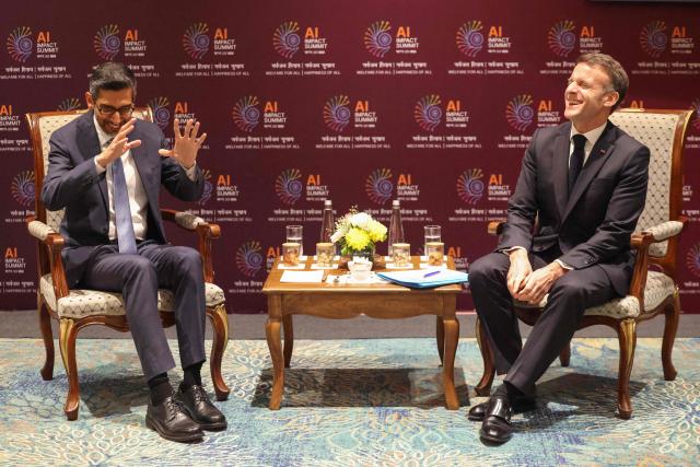 France's President Emmanuel Macron talks with Google CEO Sundar Pichai (L) during a meeting on the sidelines of the AI Impact Summit in New Delhi on February 19, 2026. (Photo by Ludovic MARIN / AFP)