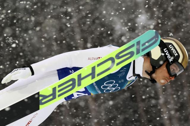 Austria's Johannes Lamparter jumps in the ski jumping competition round of the nordic combined team sprint large hill event at Predazzo Ski Jumping Stadium in Predazzo (Val di Fiemme) during the Milano Cortina 2026 Winter Olympic Games on February 19, 2026. (Photo by Anne-Christine POUJOULAT / AFP)