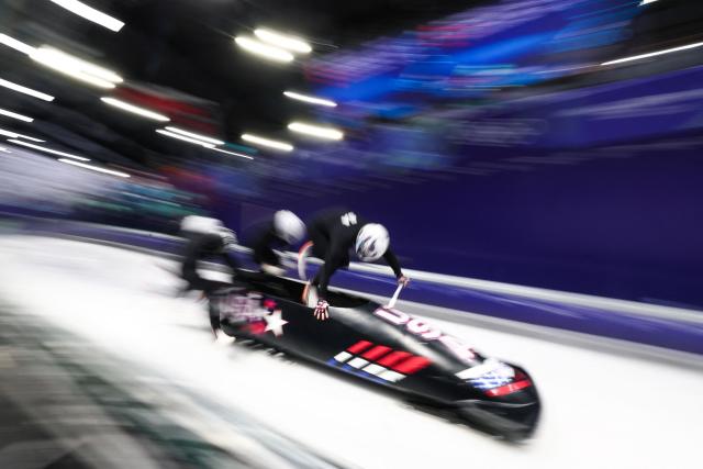 USA's Kristopher Horn pilots in the bobsleigh men's 4-man training session heat 4 at Cortina Sliding Centre during the Milano Cortina 2026 Winter Olympic Games in Cortina d'Ampezzo on February 19, 2026. (Photo by FRANCK FIFE / AFP)