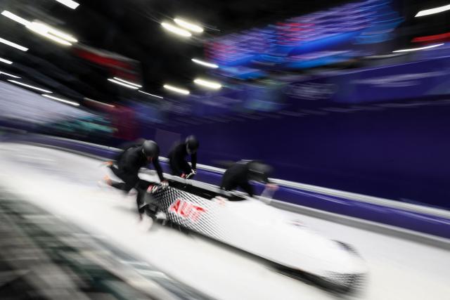 Austria's Jakob Mandlbauer pilots in the bobsleigh men's 4-man training session heat 4 at Cortina Sliding Centre during the Milano Cortina 2026 Winter Olympic Games in Cortina d'Ampezzo on February 19, 2026. (Photo by FRANCK FIFE / AFP)