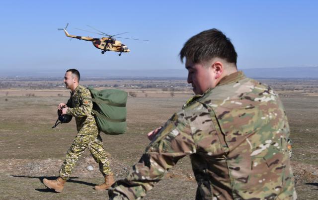 Kyrgyz paratroopers undergo parachute descending drills near the Ala-Too military grounds, some 20km from the capital Bishkek, on February 19, 2026. (Photo by Vyacheslav OSELEDKO / AFP)