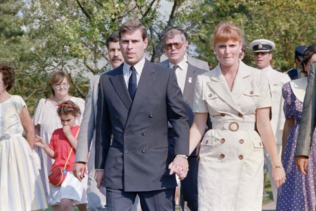 (FILES) Lady Sarah Ferguson (R) and Prince Andrew (C) walk hand in hand on July 18, 1989 at the Montreal Botanical Gardens. UK police said on February 19, 2026 officers were searching two addresses, one in eastern England and one west of London, following the arrest of ex-Prince Andrew on suspicion of misconduct in a public office. New revelations last week appeared to show Andrew sent convicted sex offender Jeffrey Epstein potentially confidential documents during his time as a UK trade envoy. (Photo by Robert GIROUX / AFP)