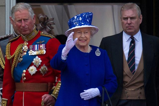 (FILES) Britain's Queen Elizabeth II (C) waves from the balcony of Buckingham Palace flanked by her sons Prince Charles, Prince of Wales (L) and Prince Andrew, Duke of York (R), following the Queen's birthday parade, 'Trooping the Colour,' in central London on June 15, 2013. UK police said on February 19, 2026 officers were searching two addresses, one in eastern England and one west of London, following the arrest of ex-Prince Andrew on suspicion of misconduct in a public office. New revelations last week appeared to show Andrew sent convicted sex offender Jeffrey Epstein potentially confidential documents during his time as a UK trade envoy. (Photo by CARL COURT / AFP)