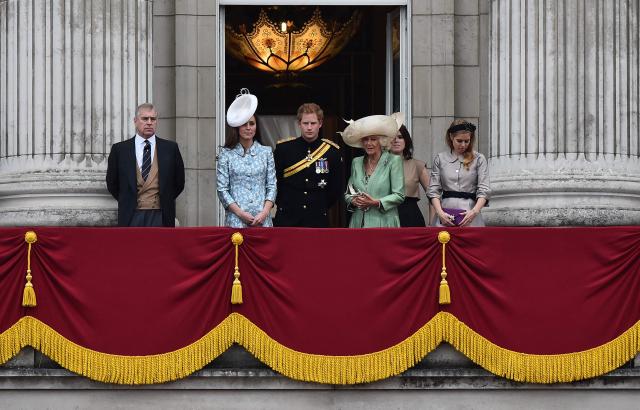 (FILES) (L to R) Britain's Prince Andrew, Duke of York, Catherine, Duchess of Cambridge, Prince Harry, Camilla, Duchess of Cornwall, Princess Eugenie of York and Princess Beatrice of York stand on the balcony of Buckingham Palace during the Queen's Birthday Parade, 'Trooping the Colour,' in London on June 13, 2015. UK police said on February 19, 2026 officers were searching two addresses, one in eastern England and one west of London, following the arrest of ex-Prince Andrew on suspicion of misconduct in a public office. New revelations last week appeared to show Andrew sent convicted sex offender Jeffrey Epstein potentially confidential documents during his time as a UK trade envoy. (Photo by Ben STANSALL / AFP)