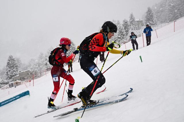 Switzerland's Caroline Ulrich (L) and Germany's Tatjana Paller compete in the women's sprint ski mountaineering semi-final 1 heat 2 during the Milano Cortina 2026 Winter Olympic Games at the Stelvio Ski Centre in Bormio (Valtellina) on February 19, 2026. (Photo by Fabrice COFFRINI / AFP)