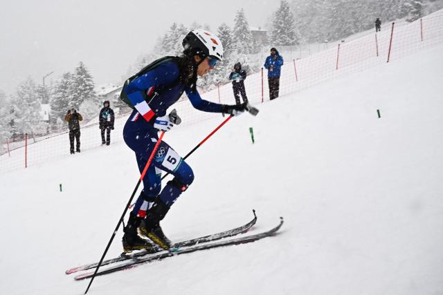 France's Margot Ravinel competes in the women's sprint ski mountaineering semi-final 1 heat 2 during the Milano Cortina 2026 Winter Olympic Games at the Stelvio Ski Centre in Bormio (Valtellina) on February 19, 2026. (Photo by Fabrice COFFRINI / AFP)