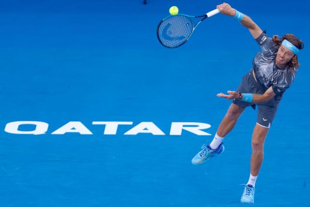 Russia's Andrey Rublev returns the ball to Greece's Stefanos Tsitsipas during their men’s singles quarterfinal match at the Qatar Open tennis tournament in Doha on February 19, 2026. (Photo by Karim JAAFAR / AFP)