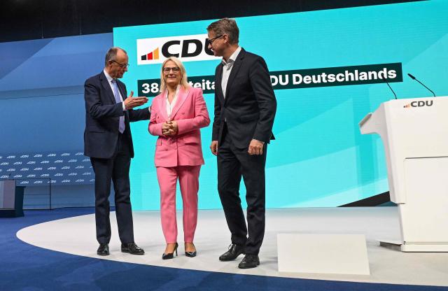 German Chancellor Friedrich Merz (L) and Secretary General of Germany's Christian Democratic Union (CDU) Carsten Linnemann (R) speak with Deputy Secretary General of the CDU Christina Stumpp as they tour the venue ahead of the upcoming party congress of the CDU in Stuttgart, southern Germany on February 19, 2026. (Photo by THOMAS KIENZLE / AFP) / ALTERNATIVE CROP
