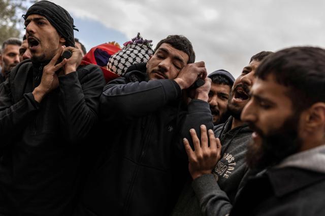 Friends and family carry the body of 19-year-old Nasrallah Mohammad Siam, during his funeral in Mikhams, in the Israeli-occupied West Bank on February 19, 2026, after he was killed the day before during a Israeli settler attack. Violence in the Palestinian West Bank, which Israel has occupied since 1967, has soared since the Hamas attack on Israel triggered the Gaza war in October 2023. (Photo by JOHN WESSELS / AFP)