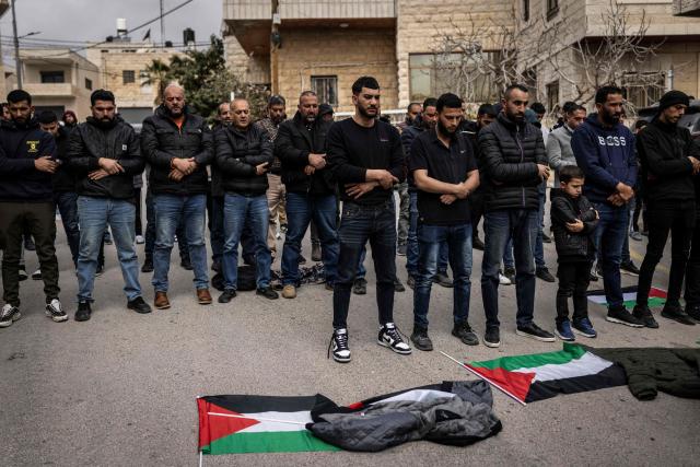 Friends and family pray during the funeral of 19-year-old Nasrallah Mohammad Siam, the day after he was killed in an Israeli settler attack, in the village of Mikhams, northeast of Jerusalem, in the Israeli-occupied West Bank on February 19, 2026. Violence in the Palestinian West Bank, which Israel has occupied since 1967, has soared since the Hamas attack on Israel triggered the Gaza war in October 2023. (Photo by JOHN WESSELS / AFP)