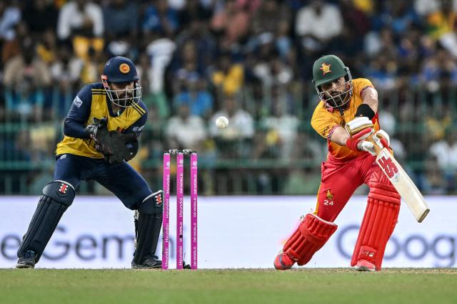 Zimbabwe's captain Sikandar Raza (R) plays a shot as Sri Lanka's wicketkeeper Kusal Mendis watches during the 2026 ICC Men's T20 Cricket World Cup group stage match between Sri Lanka and Zimbabwe at the R Premadasa Stadium in Colombo on February 19, 2026. (Photo by Ishara S. KODIKARA / AFP)