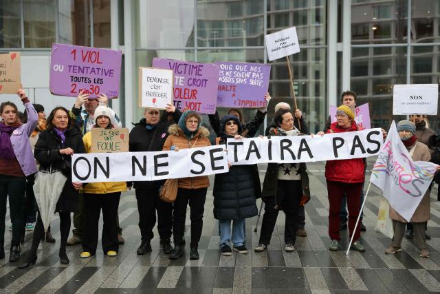 Women hold a banner which reads as "We will not be silenced" as they gather outside the Paris courthouse in support of French actress Judith Godreche in Paris on February 19, 2026. Judith Godrèche, a leading figure of #MeToo in France, has been summoned on February 19 for a procedural hearing before the Paris court, following a defamation complaint by filmmaker Jacques Doillon, whom she accuses of raping her when she was 15. (Photo by Thomas SAMSON / AFP)