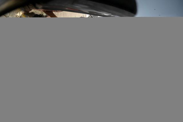 TOPSHOT - Rescue workers carry a victim’s body to hospital after recovering it from the debris of a collapsed building following an explosion in Karachi on February 19, 2026. A building collapse caused by an explosion in Pakistan's southern megacity of Karachi killed at least 16 people on February 19, including children, officials said. (Photo by Rizwan TABASSUM / AFP)