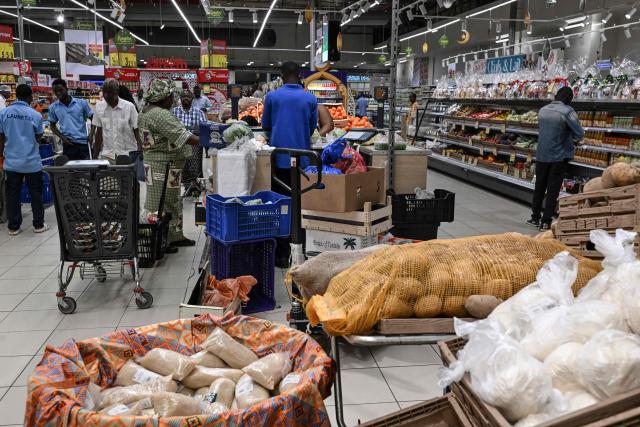 Customers shop at a supermarket during the holy month of Ramadan in Abidjan, on Febuary 19, 2026. (Photo by Issouf SANOGO / AFP)
