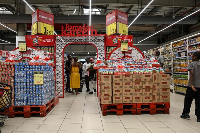 Customers shop at a supermarket during the holy month of Ramadan in Abidjan, on Febuary 19, 2026. (Photo by Issouf SANOGO / AFP)