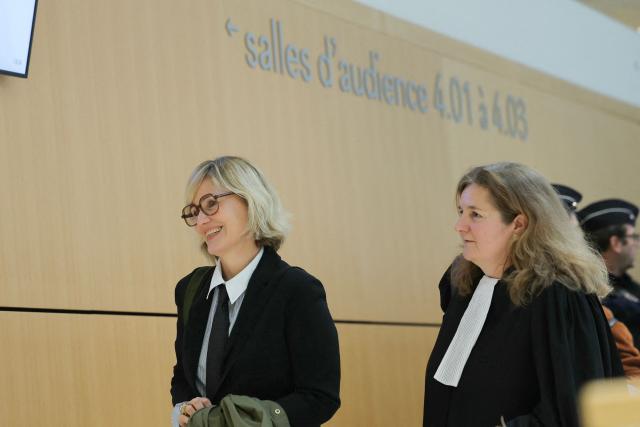 French director and screennwriter Judith Godreche (C) accompanied by French lawyer Laure Heinich arrives at the Paris courthouse in Paris on February 19, 2026, for a procedural hearing before the Paris court, following a defamation complaint by filmmaker Jacques Doillon, whom she accuses of raping her when she was 15. (Photo by Thomas SAMSON / AFP)