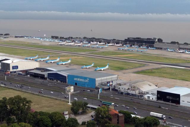 In this aerial view airplanes remain grounded on the tarmac of Jorge Newbery airport as flights are cancelled during a 24-hour general strike called by workers unions against President Javier Milei’s labor reform in Buenos Aires on February 19, 2026. The Argentine government faces on February 19 the fourth general strike of its administration, on the same day the Chamber of Deputies will debate a controversial labor reform pushed by ultraliberal President Javier Milei, which was already approved by the Senate last week. (Photo by Luis ROBAYO / AFP)