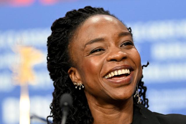 Chadian actress Achouackh Abakar Souleymane smiles during a press conference for the film "Soumsoum, la nuit des astres" (Soumsoum, the Night of the Stars) presented in competition at the 76th Berlinale, Europe's first major film festival of the year, in Berlin on February 19, 2026. (Photo by RALF HIRSCHBERGER / AFP)
