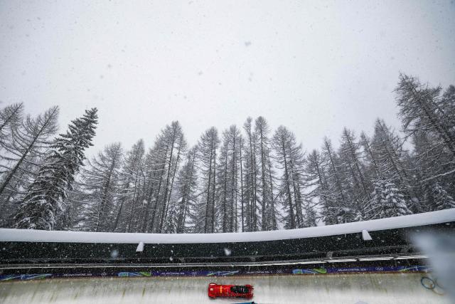 China's Ying Qing pilots in the bobsleigh women's 2-woman training session heat 5 at Cortina Sliding Centre during the Milano Cortina 2026 Winter Olympic Games in Cortina d'Ampezzo on February 19, 2026. (Photo by FRANCK FIFE / AFP)