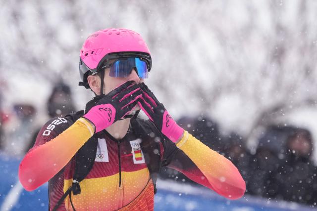 Gold medallist Spain's Oriol Cardona Coll celebrates after crossing the finish line to win the men's sprint ski mountaineering final during the Milano Cortina 2026 Winter Olympic Games at the Stelvio Ski Centre in Bormio (Valtellina) on February 19, 2026. (Photo by Dimitar DILKOFF / AFP)
