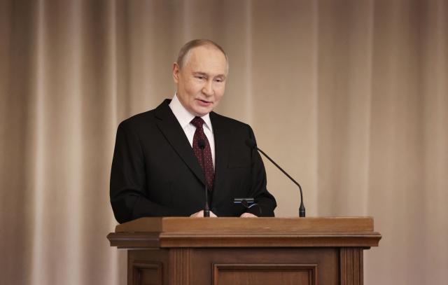 In this pool photograph distributed by the Russian state agency Sputnik, Russia's President Vladimir Putin speaks at an annual meeting of judges in Moscow on February 19, 2026. (Photo by Valery SHARIFULIN / POOL / AFP)