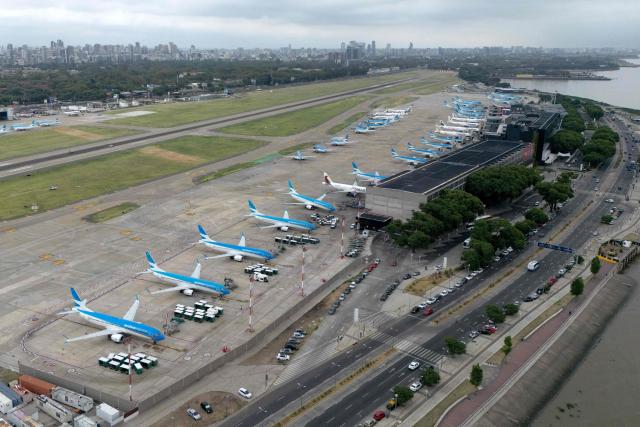 In this aerial view airplanes remain grounded on the tarmac of Jorge Newbery airport as flights are cancelled during a 24-hour general strike called by workers unions against President Javier Milei’s labor reform in Buenos Aires on February 19, 2026. The Argentine government faces on February 19 the fourth general strike of its administration, on the same day the Chamber of Deputies will debate a controversial labor reform pushed by ultraliberal President Javier Milei, which was already approved by the Senate last week. (Photo by Luis ROBAYO / AFP)