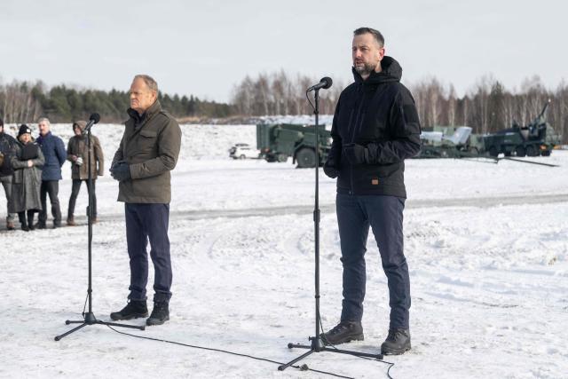 Poland's Deputy Prime Minister and Minister of Defence Wladyslaw Kosiniak-Kamysz (R) speaks as Prime Minister Donald Tusk (L) listens during a press conference after an open test of unmanned weapon systems conducted by the Polish Armaments Group (Polska Grupa Zbrojeniowa) at the Military Institute of Armament Technology training ground in Zielonka, Warsaw suburbia, on February 19, 2026. (Photo by Wojtek RADWANSKI / AFP)