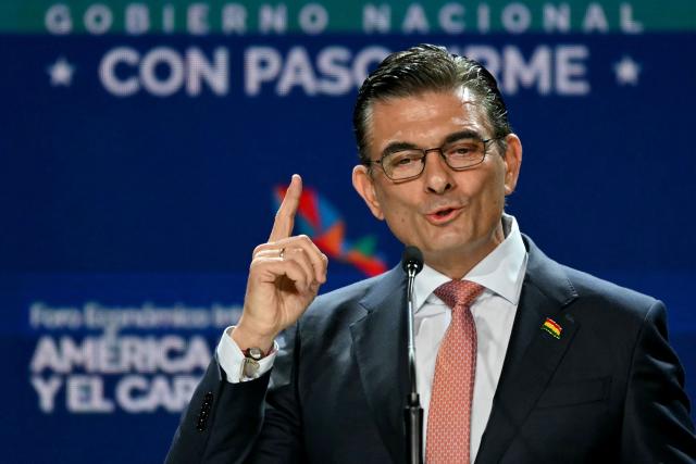 (FILES) Bolivia's President Rodrigo Paz speaks during the inauguration of the Latin America and the Caribbean International Economic Forum at the Panama Convention Center in Panama City on January 28, 2026. President Rodrigo Paz stated on February 19, 2026 early morning that Bolivia has begun to resolve its economic crisis of recent years, after cutting fuel subsidies and reducing its fiscal deficit, in a review of his first 100 days in office. (Photo by Martin BERNETTI / AFP)