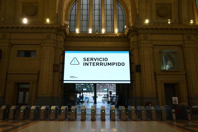 An electronic board displays "Service interrupted" at Constitucion train station, closed during a 24-hour general strike called by workers unions against President Javier Milei’s labor reform in Buenos Aires on February 19, 2026. The Argentine government faces on February 19 the fourth general strike of its administration, on the same day the Chamber of Deputies will debate a controversial labor reform pushed by ultraliberal President Javier Milei, which was already approved by the Senate last week. (Photo by Luis ROBAYO / AFP)